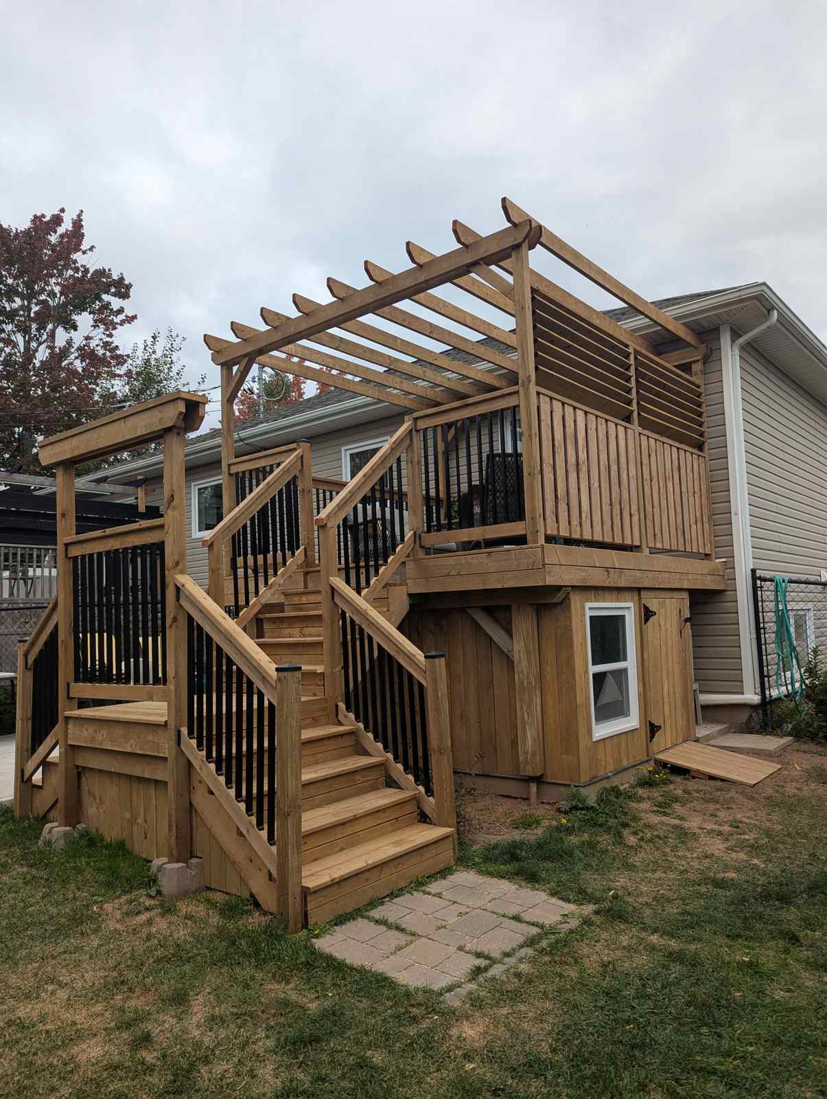 Completed multi-level deck with pergola on Ayers Avenue by Valhalla Construction