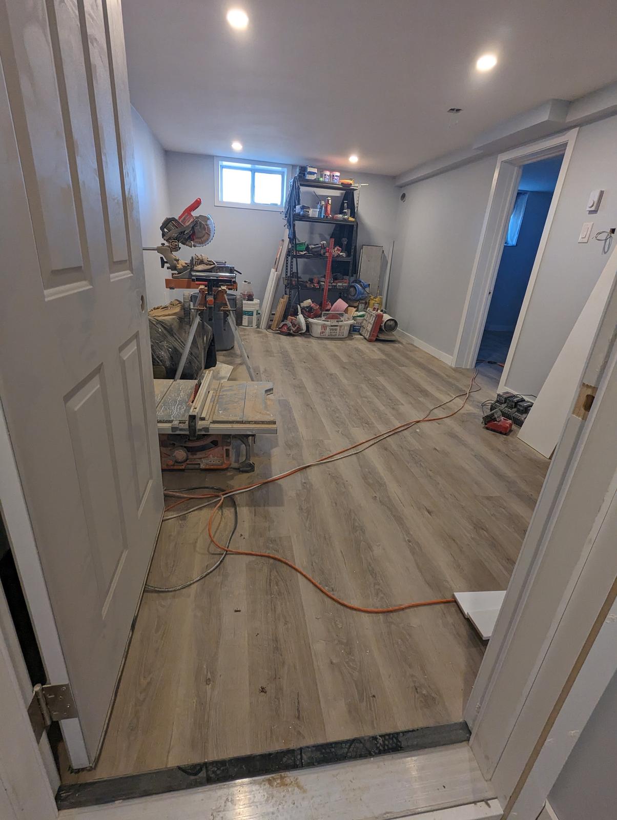 Luxury vinyl plank flooring installed through a finished basement, Riverview NB