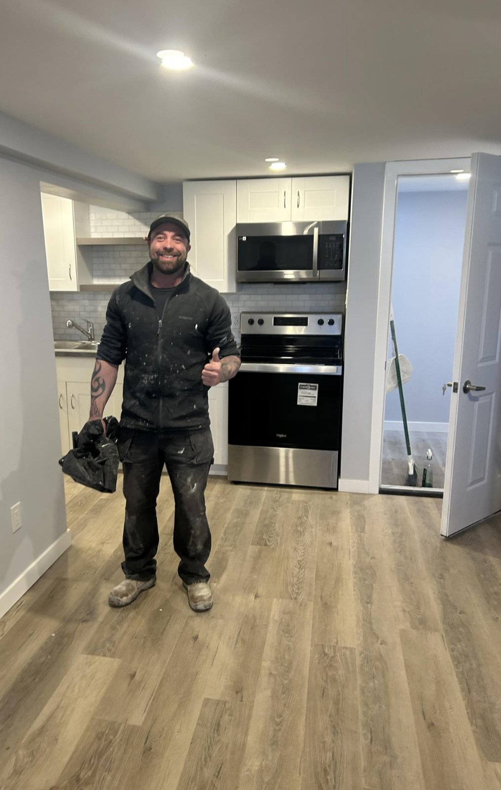 Finished basement suite kitchenette with shaker cabinets, subway tile backsplash and appliances by Valhalla Construction, Riverview NB