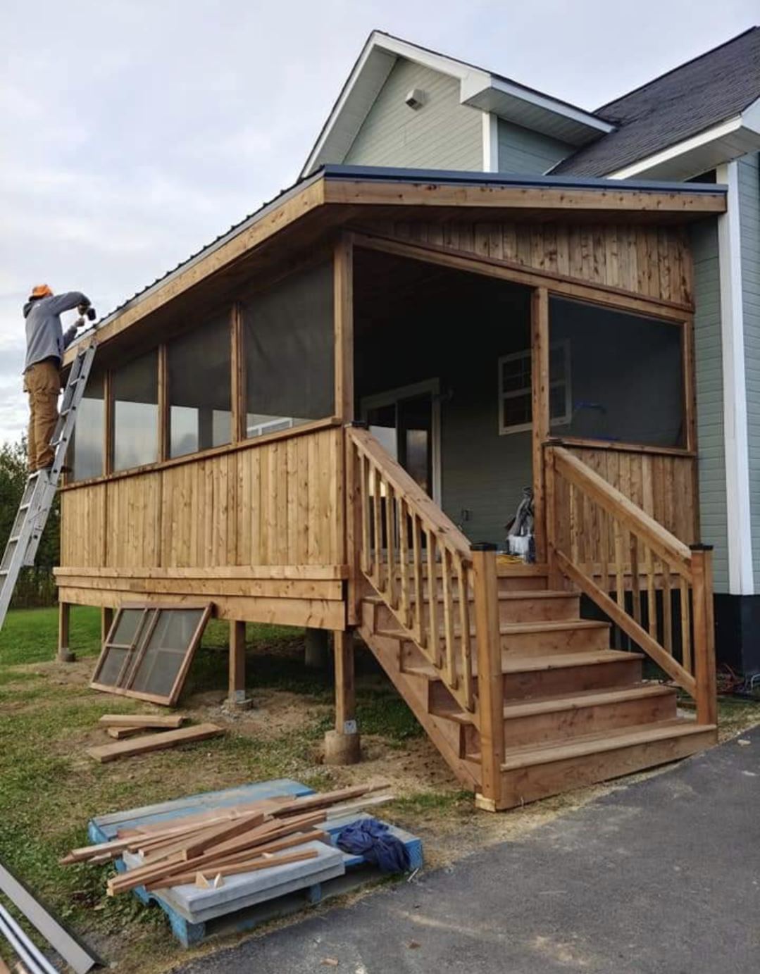 Completed roofed deck structure with stairs and screening by Valhalla Construction