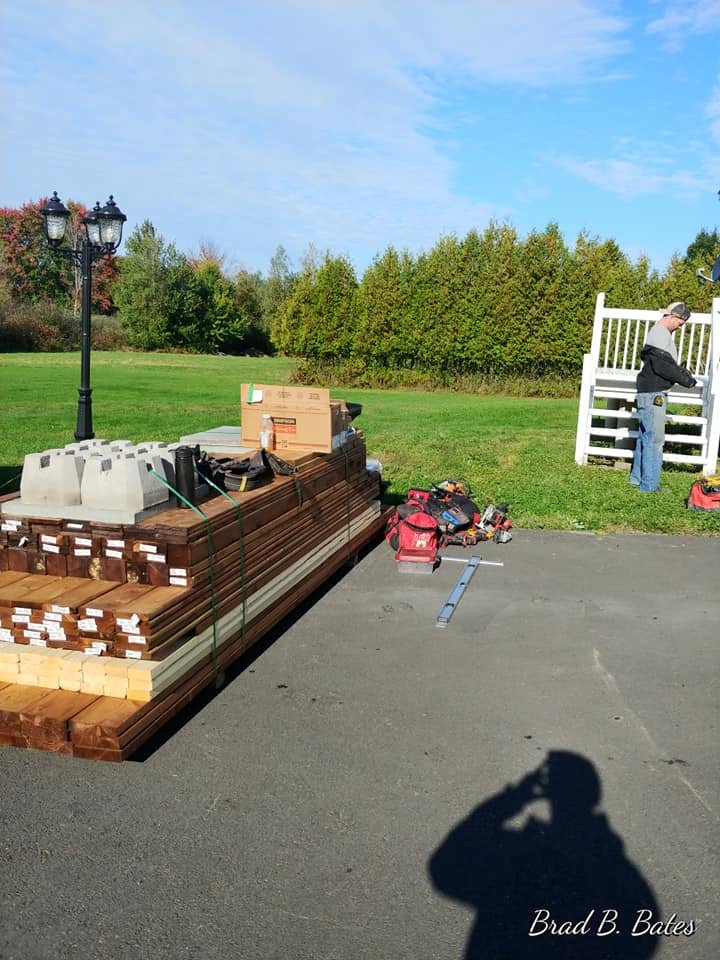 Lumber and materials staged for a covered deck build