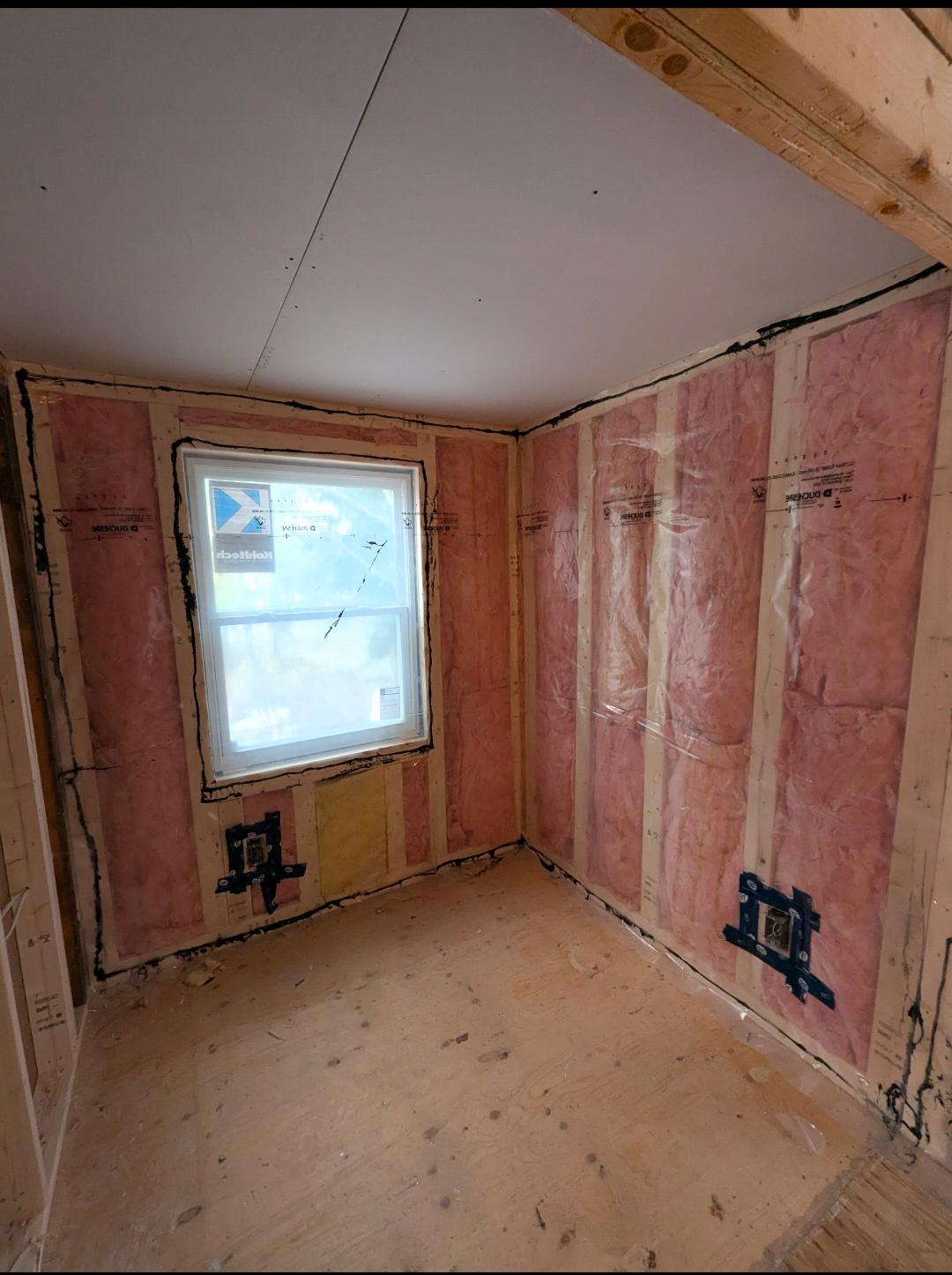 New insulation installed in bedroom exterior walls during renovation
