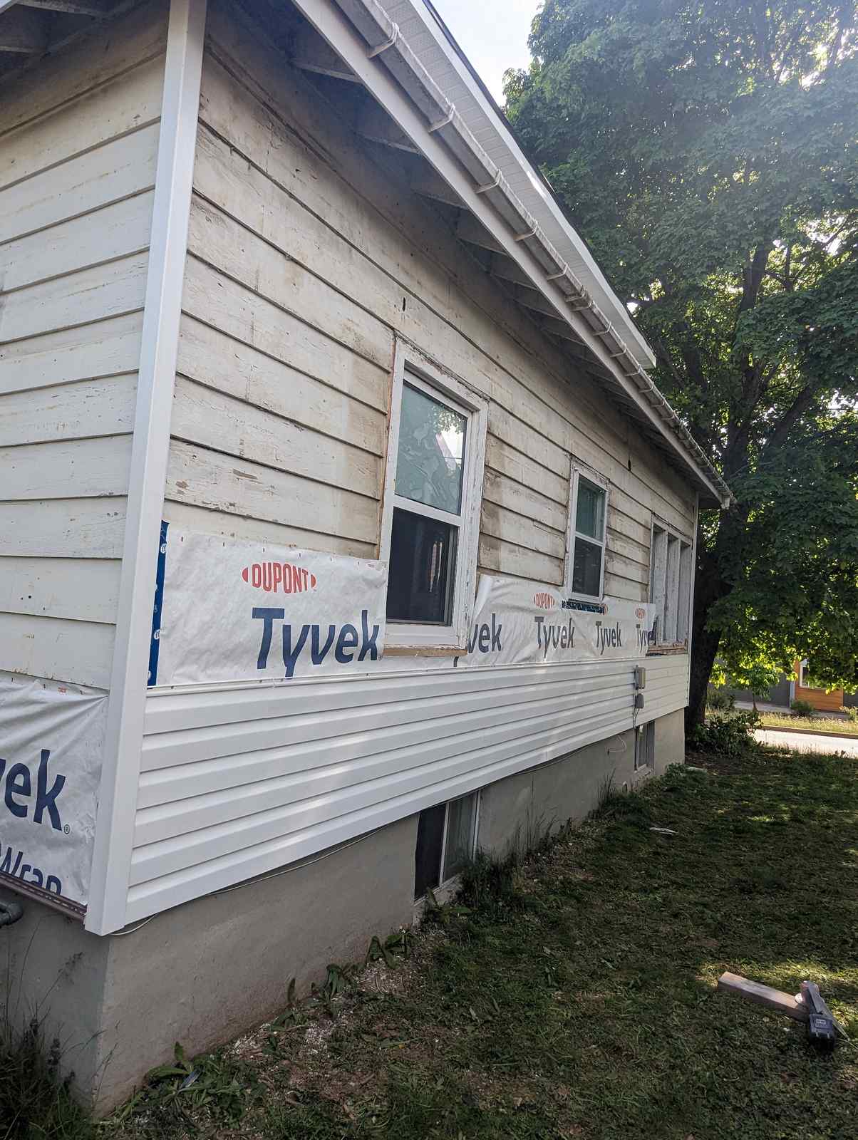 Old siding partially removed during a Dieppe, NB siding renovation