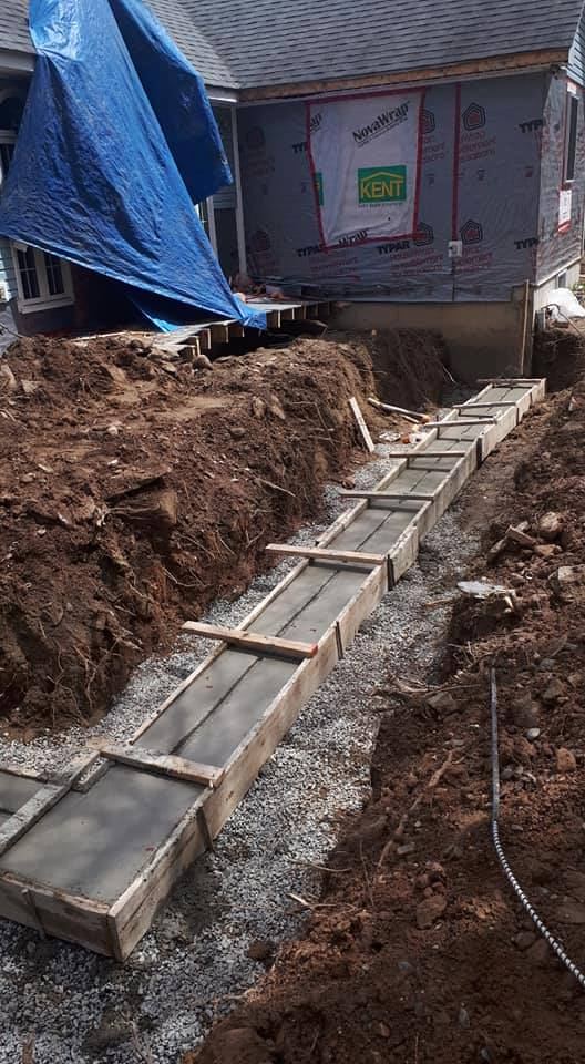 Poured concrete footings in trench for a home addition foundation