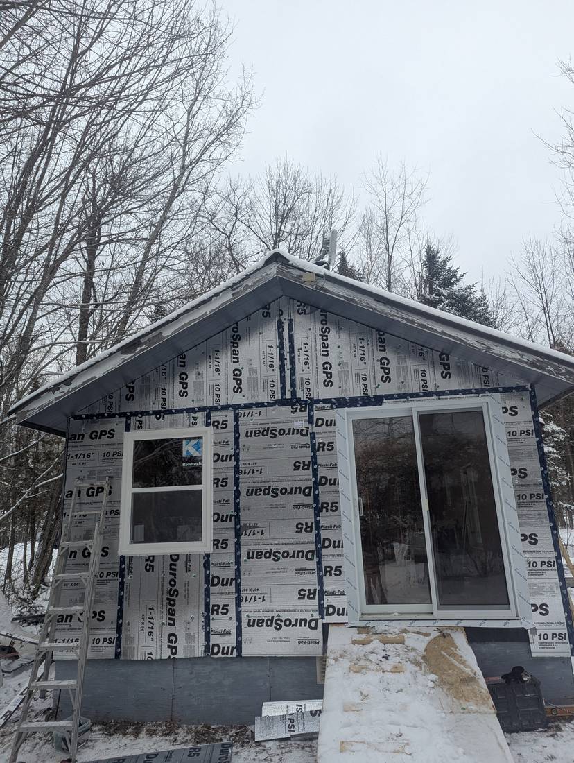 Continuous R5 rigid foam insulation with taped seams on a gable end