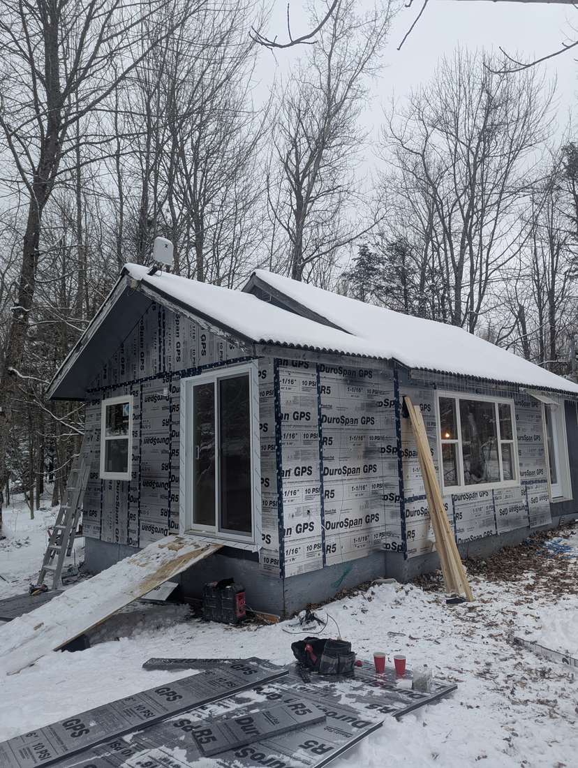 Continuous exterior rigid foam insulation across a full side elevation